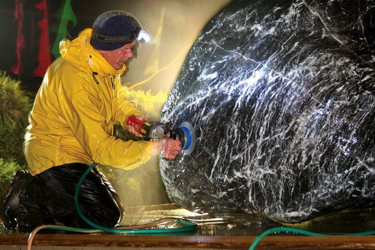 A monk uses specialist stone polishing equipment to clean the shaligram at the Samadhi of Guru Sri Subramanium