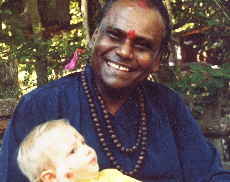 Guru Sri Subramanium holding a young child