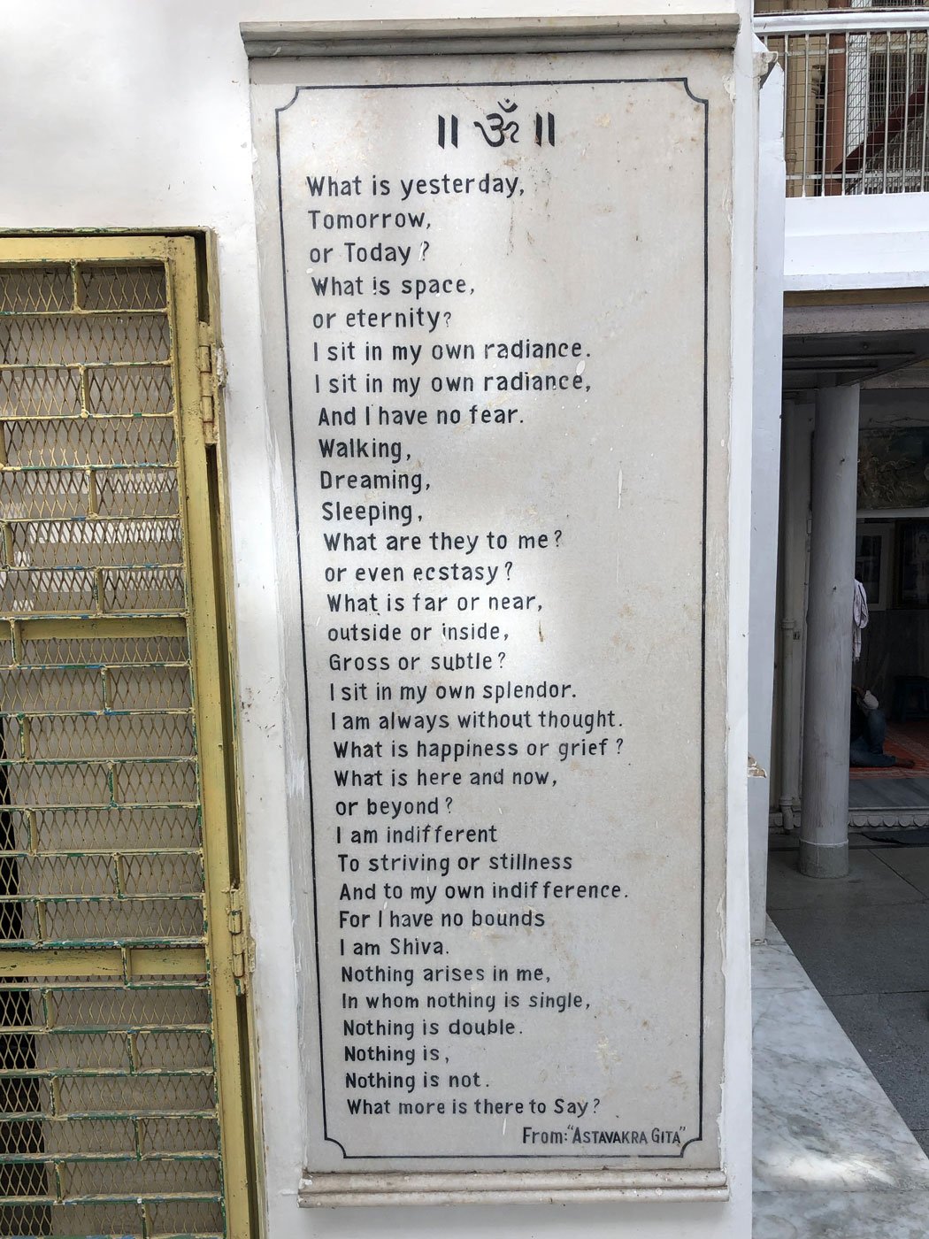 A marble plaque featuring a quote from the Astavakra Gita
