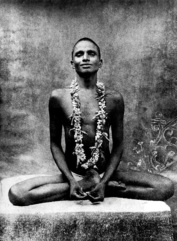 A young Bhagwan Nityananda in meditation wearing a flower garland
