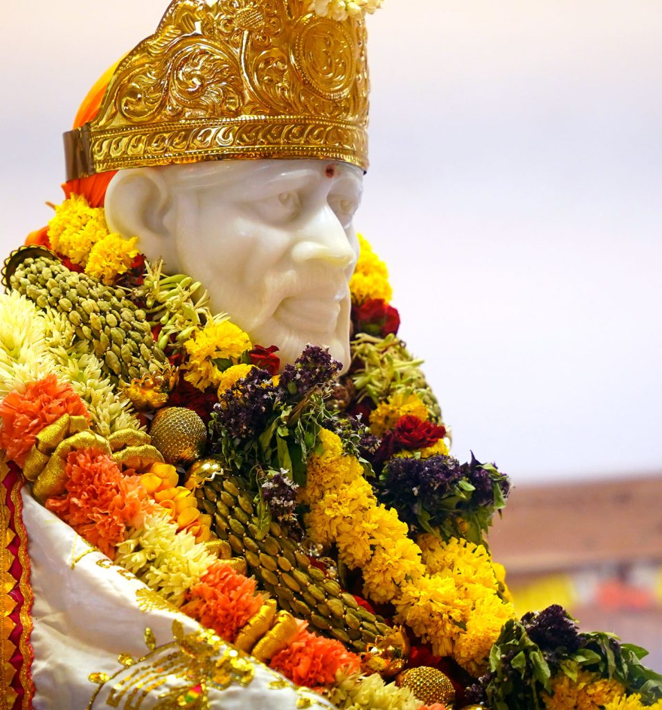 A white marble murthi of Shirdi with garlands